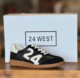 Black and white sneaker with '24' on a wooden surface in front of a '24 West' branded box.