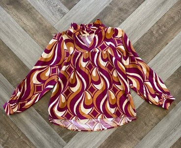 Patterned blouse on a wooden floor