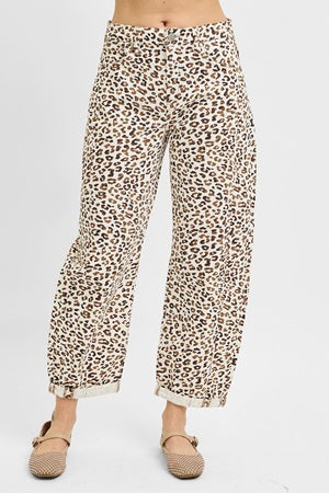 Leopard print pants worn by a person on a white background