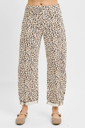 Leopard print pants worn by a person on a white background