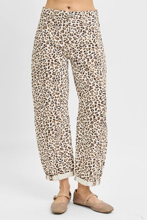 Leopard print pants worn by a person on a white background