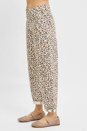 Leopard print pants worn by a person on a white background