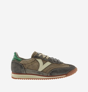 Brown and green sneaker with a brand logo on a white background