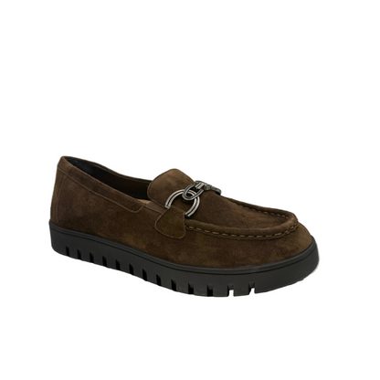 A brown suede slip-on loafer with a black lug sole and a silver metal ring detail on the vamp.