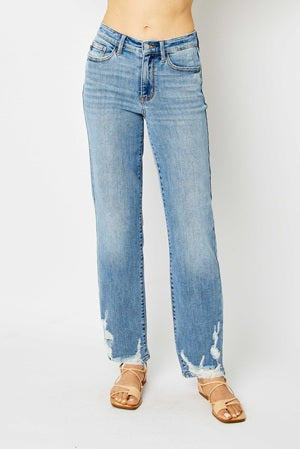 Light blue jeans worn by a person on a white background