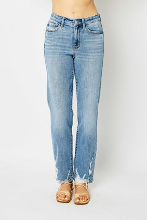 Light blue jeans worn by a person on a white background
