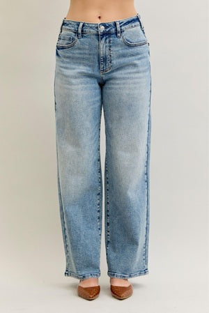 Light blue jeans worn by a person on a plain background