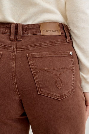 Brown pants with a visible brand label on a neutral background