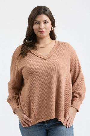 Woman wearing a brown sweater on a white background