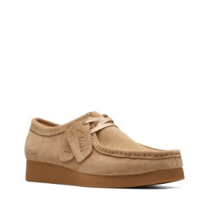 Tan suede shoe with a brand tag on a white background