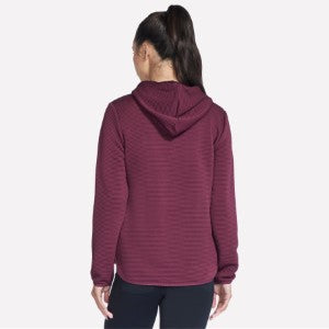 Person wearing a maroon hoodie on a white background
