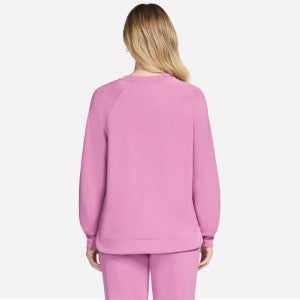 Person wearing a pink sweatshirt and pants on a white background
