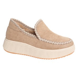 Beige slip-on shoe with a textured sole on a white background