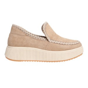 Beige slip-on shoe with textured sole on a white background