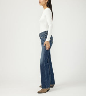 Woman wearing blue jeans and a white top on a white background