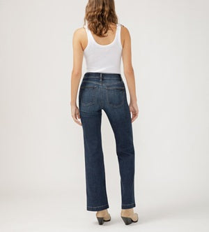 Person wearing blue jeans and a white tank top on a plain background