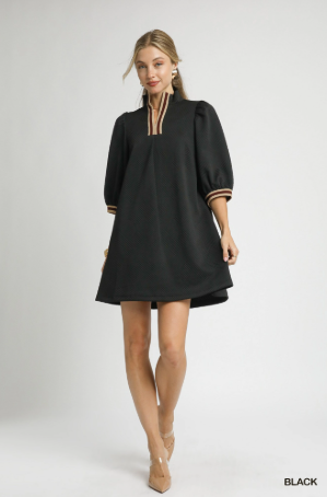 Woman wearing a black dress with a white background