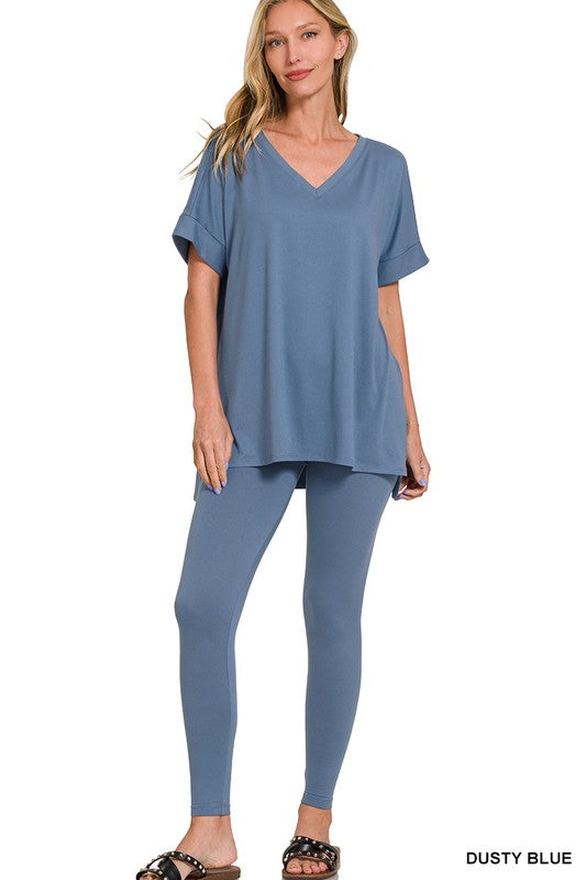 Woman wearing a dusty blue outfit on a white background