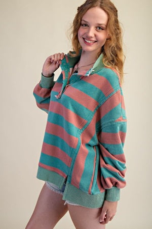 Woman wearing a striped sweater with a plain background